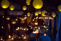 Chinese lanterns in warm color + beautiful candles around the wedding área