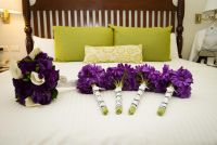 My purple bouquet provided by the resort, and my bridesmaids and groomsladies silk bouquets ordered via Afloral.com