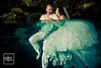 *
Romantic couple embrace floating half underwater