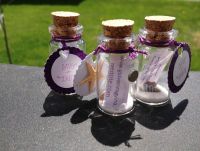 Completed Message-in-a-bottle Save-the-dates with magnets, appox 1.5" tall.