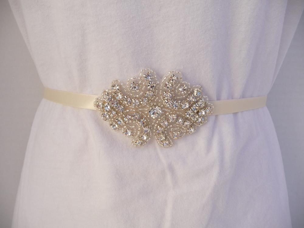 This Handmade Bridal Sash features a genuine Crystal Rhinestone Embellishment sewn onto a double faced satin Ivory ribbon.  Custom orders welcome.  Buy at www.BellaCescaBoutique.Etsy.com