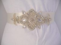 This Bridal Sash Features Vintage Inspired Genuine Crystal Rhinestone Embellishment sewn onto an Ivory double faced satin ribbon.  Tie into desired style.  Buy at www.BellaCescaBoutique.Etsy.com