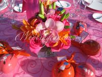 fyusha and orange centerpiece. Combination of  lilies, cymbidium orchids and fyusha roses