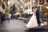 The bride and groom pose for portraits in the alleyway near the bakeries and markets of Santa Margherita, Italy. 