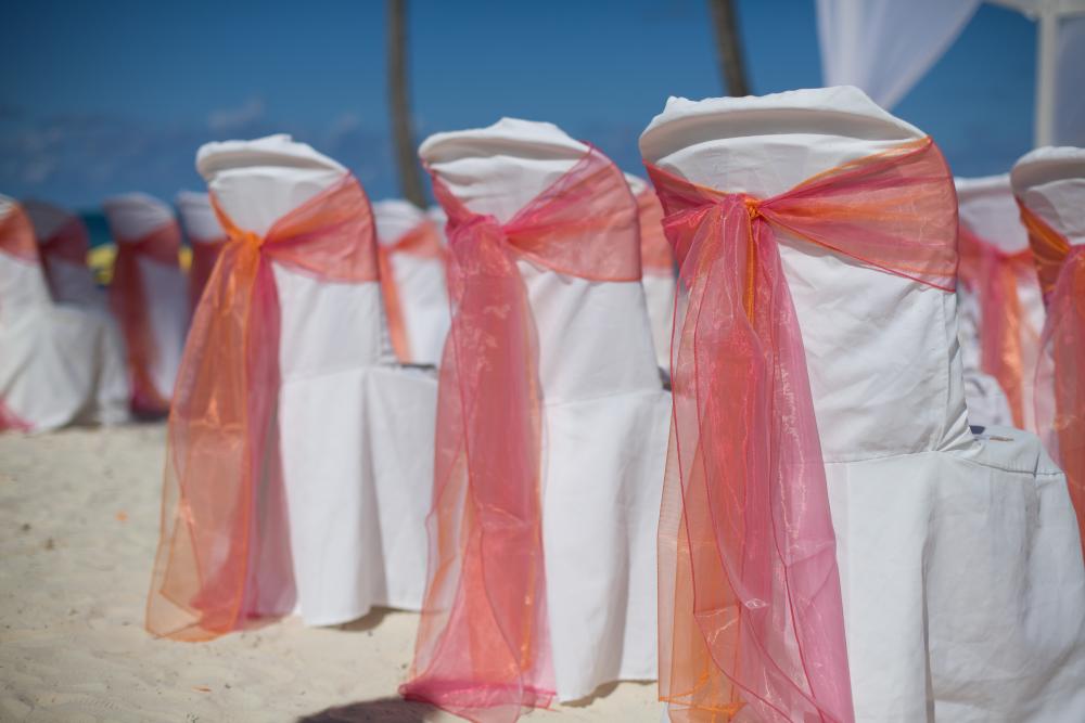 Pink and Orange wedding decor (chair sashes, seashells, table runners, baskets)