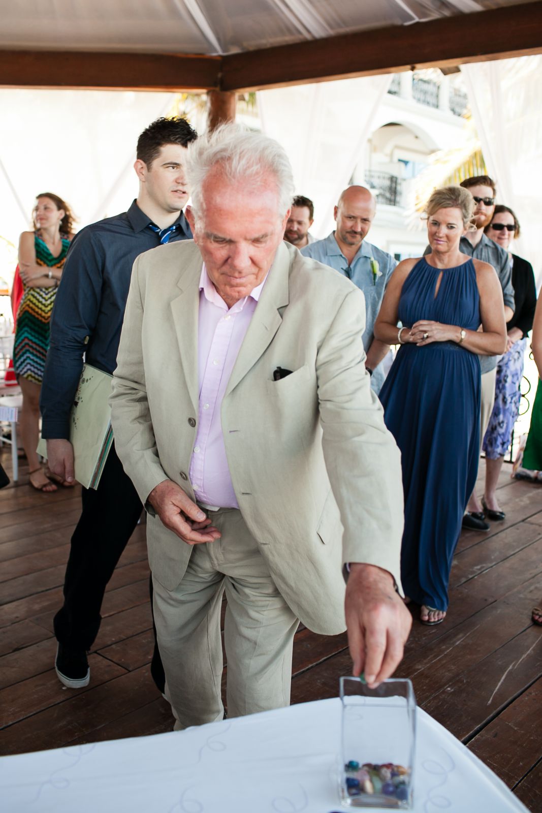 We had a simple 20-minute ceremony. In lieu of a sand ceremony we opted for a "stone ceremony". We brought glass stones with us and had them in a basket, each guest took one when getting seated for the wedding. Then, during the wedding we invited each of 