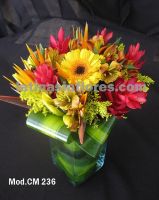 orange alstroemeria, red ginger, bird of paradise, yellow gerbera daisies and lilies with goldenrod wedding centerpiece