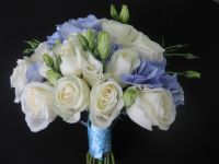 white roses and lisianthus with a touch of blue hydrangeas bouquet