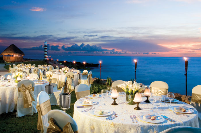  www.crystalwaterweddings.com Experienced travel agents who strongly value providing first class service and have a deep passion for destination weddings.  Dreams Cancun Resort & Spa.  Nighttime dinner set-up during a spectacular sunset on the beach.  
