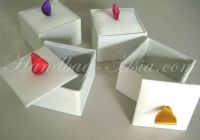 Ivory silk favor box shown with sweet ribbon embellishment.