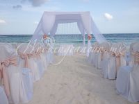 beach ceremony with white huupah