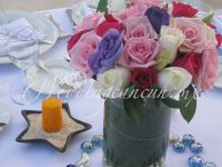 white roses, pink roses and deep pink roses with purple lisianthus centerpiece