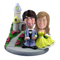 This custom bobblehead has a great background including castle, rose bush and rocky steps. The custom bobblehead groom is in handsome blue suit and the bride is in bright yellow wedding dress. Itâ€™s a perfect item to be made as a wedding cake topper